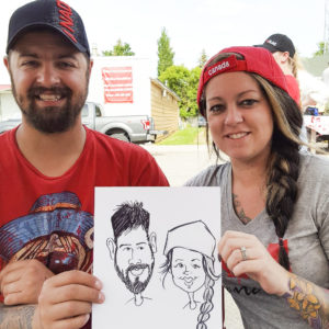 couple at outdoor event with caricatures as entertainment