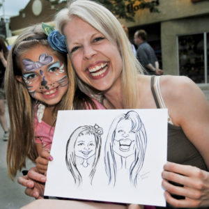 mother and young girl with their fringe festival saskatoon caricature