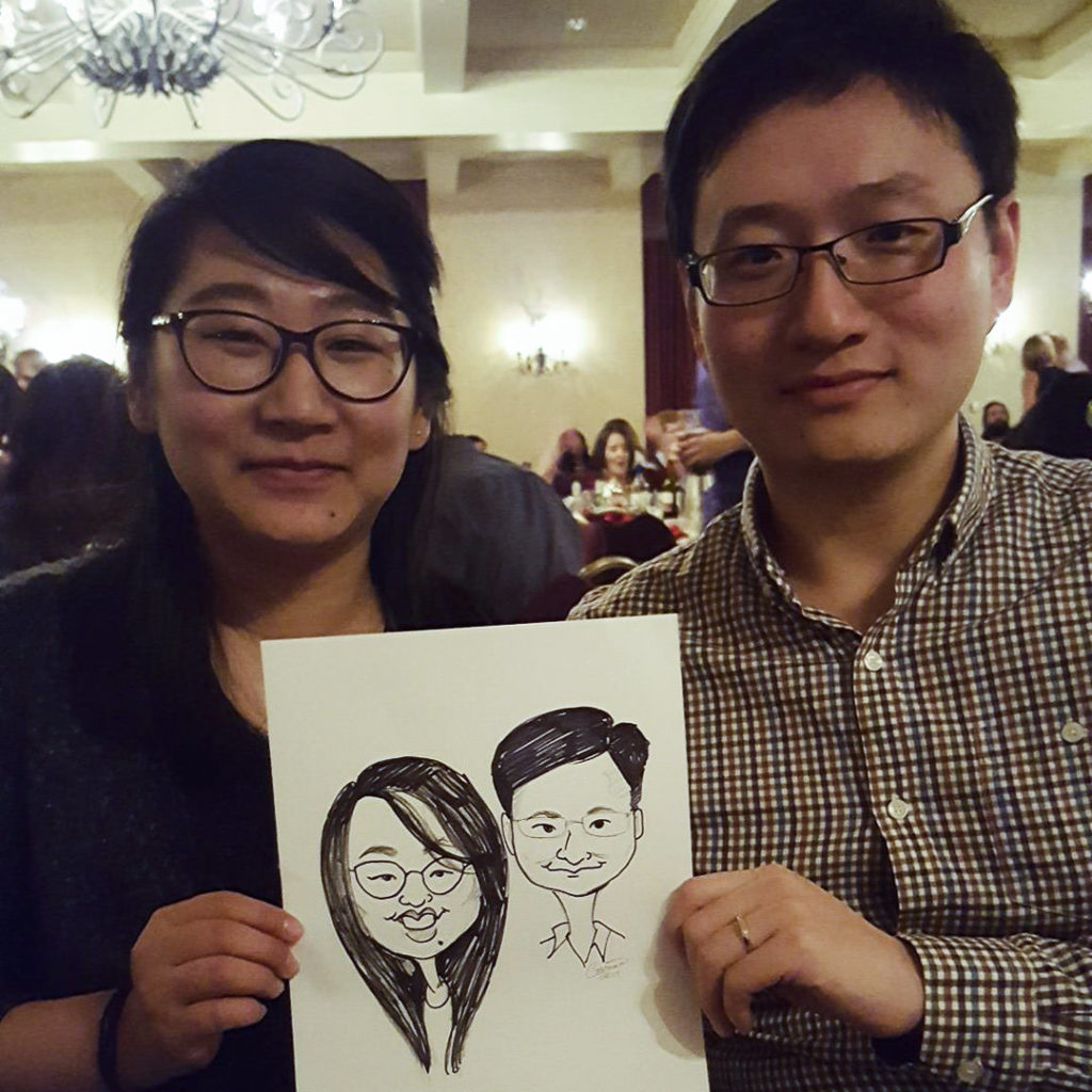 asian couple with caricature at a wedding
