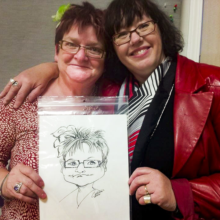 Corrina and her friend with a caricature