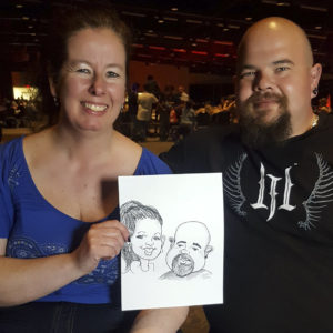 wedding guests with a caricature from the event entertainment in moose jaw