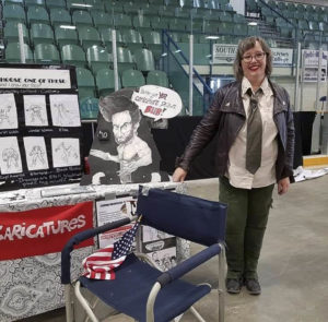 Caricature artist with her comic convention display Regina Expo