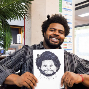 Black man with comb in hair proudly presenting his custom caricature art