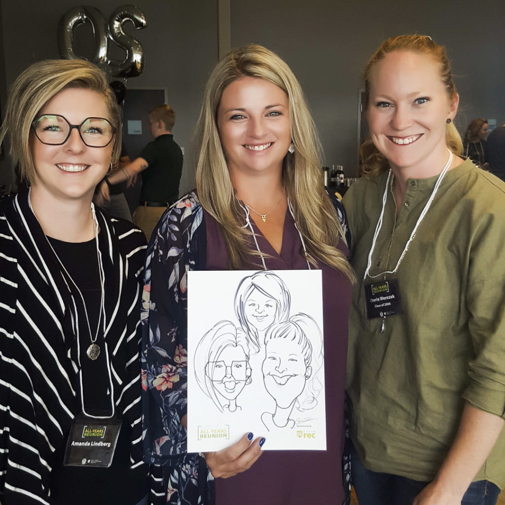 three women at a reunion holding their caricature from event entertainer