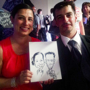 Couple at wedding reception with caricature entertainment