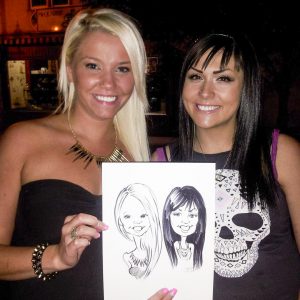 Two stylish women and their caricature art at Saskatoon Event