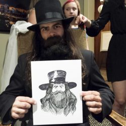 Man with epic hat caricature at comic convention