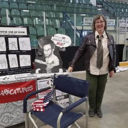 Caricature artist with her comic convention display Regina Expo